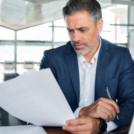 Tax professional checking paperwork related to late filing and payment penalties.