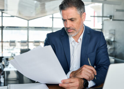 Tax professional checking paperwork related to late filing and payment penalties.