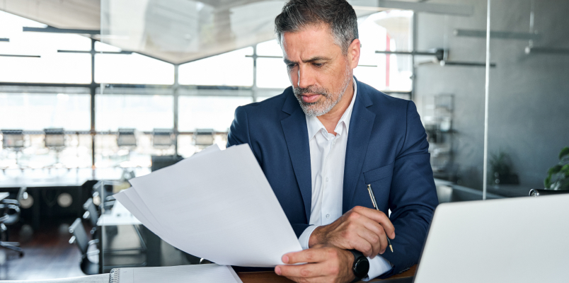 Tax professional checking paperwork related to late filing and payment penalties.